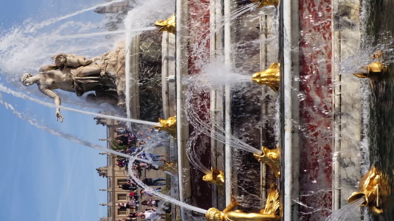Versailles, France - April 21, 2021: View of a water fountain in the Park of Versailles. Vertical