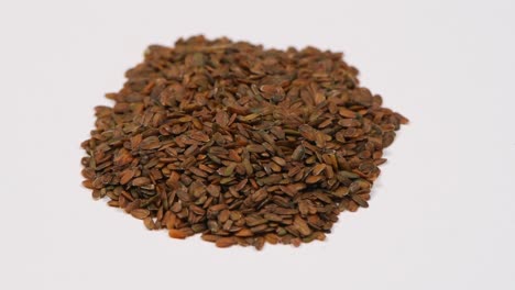 a heap of quality seeds of mathiola. clockwise rotation. side view. loop motion. rotation 360.