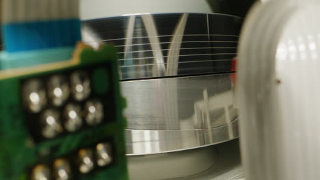 old video recorder inside close-up, vhs. retro player in neon blue light, vintage video cassette broadcasting, audio tape.