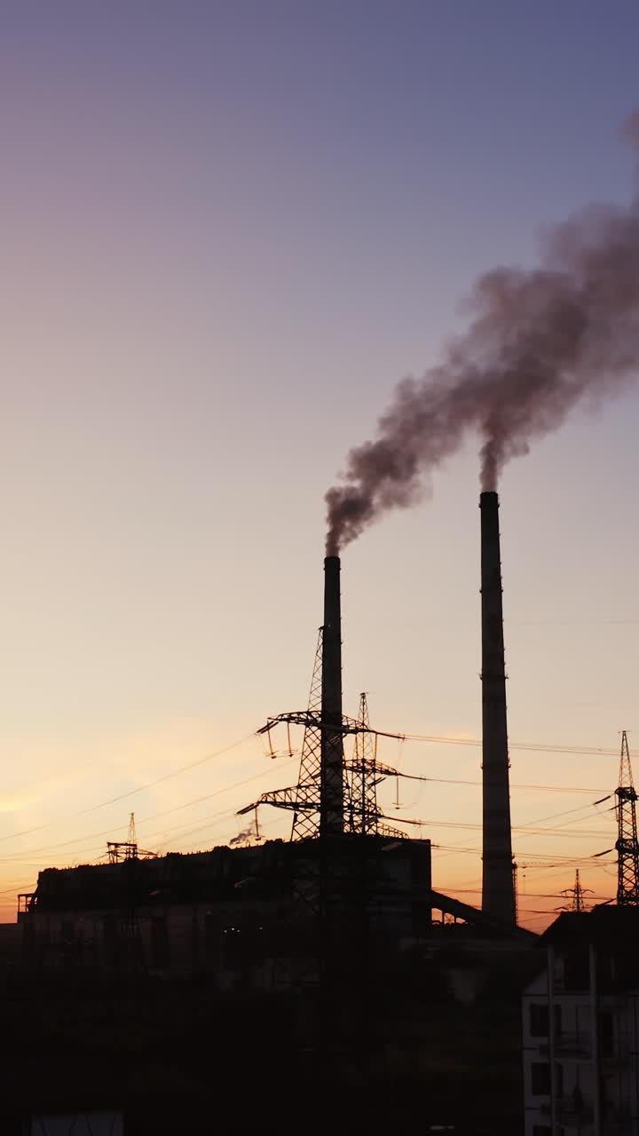 Power plant with pipes and smoke. Environmental pollution problem and nature environment Vertical video