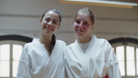 front view of happy caucasian girls in kimono looking at camera