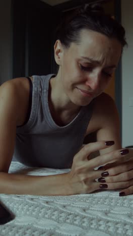 woman crying on bed