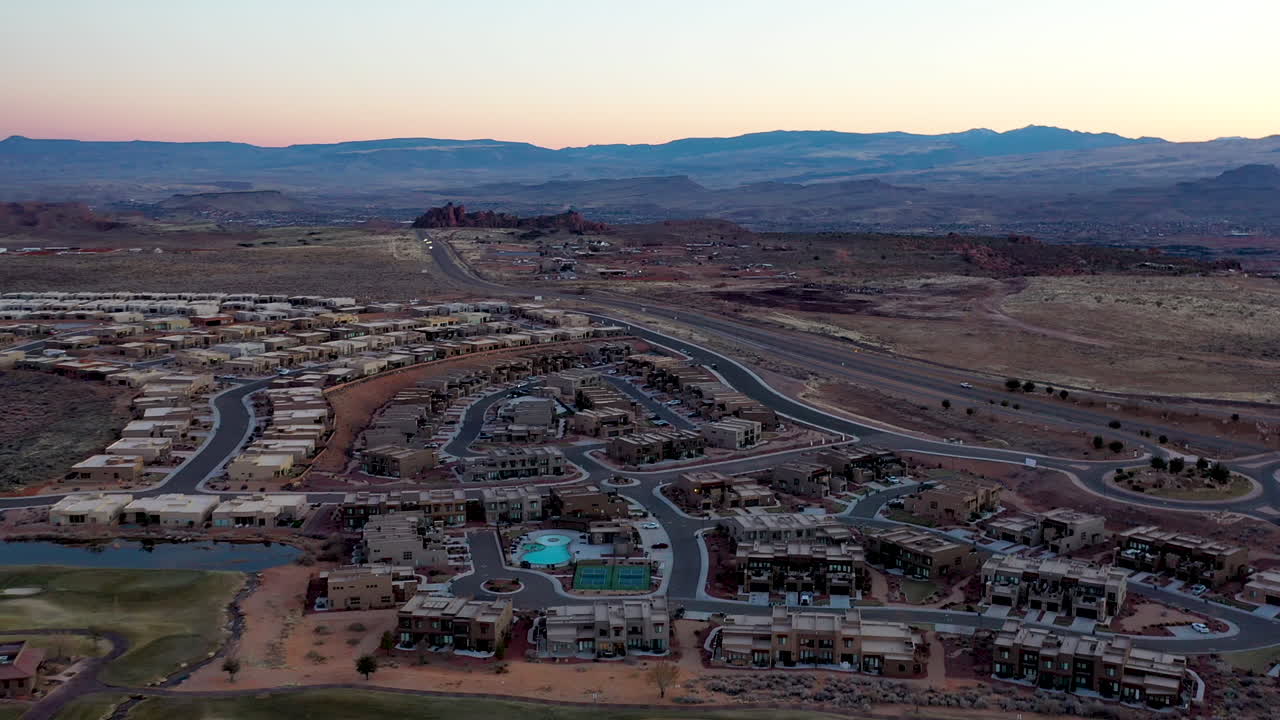St. George, Utah USA. Beautiful revealing aerial shot over the houses and roads and of the hills and mountains at dusk. Establishing shot of the area