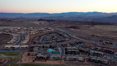 st. george, utah usa. beautiful revealing aerial shot over the houses and roads and of the hills and mountains at dusk. establishing shot of the area