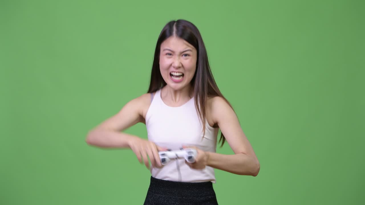 Young beautiful Asian businesswoman playing games