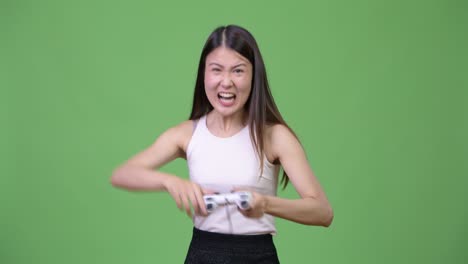 young beautiful asian businesswoman playing games