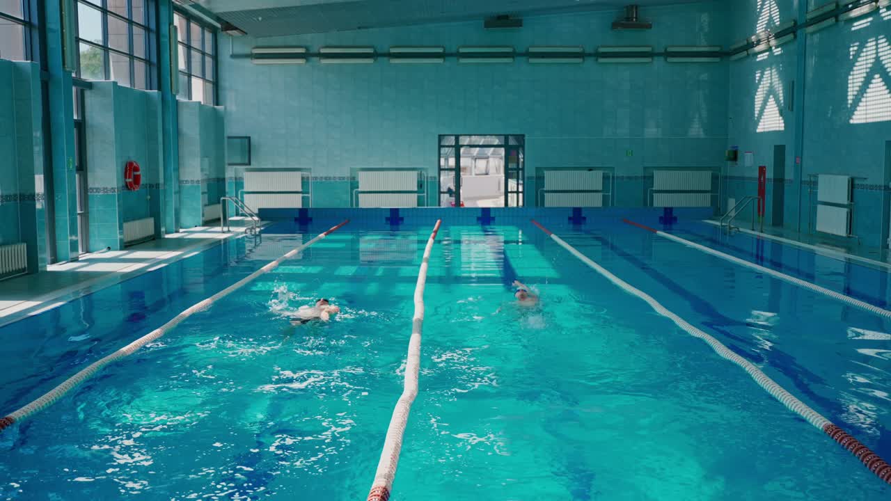 People Swimming in an Indoor Pool
