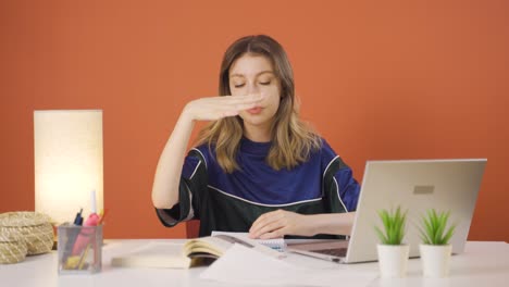 Young-woman-working-on-laptop-throws-files-angrily.