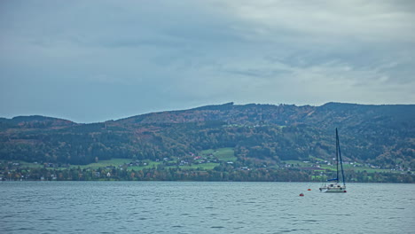 tied boat buoyant in water landscape green mountains clouds in sky, time lapse