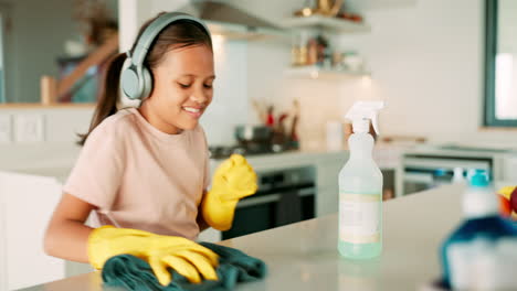 girl child, headphones and cloth for cleaning