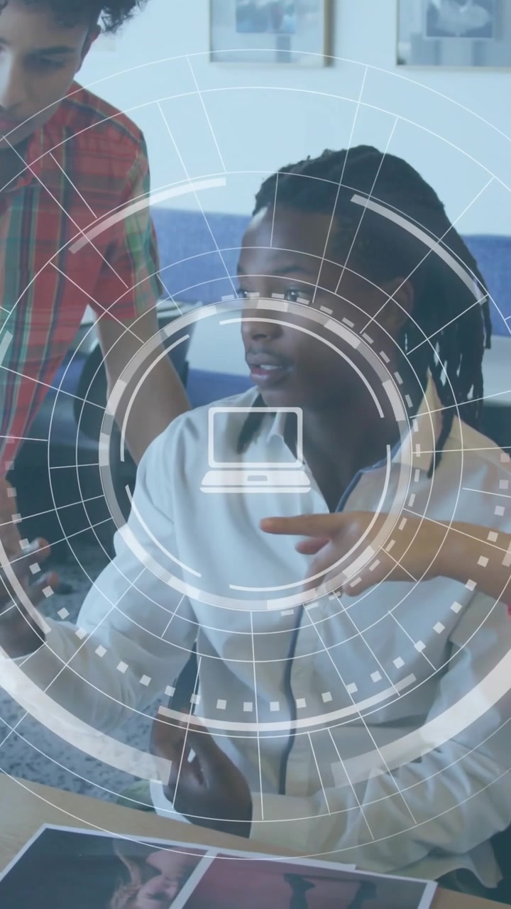Vertical video: Seated man examining docs, woman leaning and pointing for design, HUD hovering