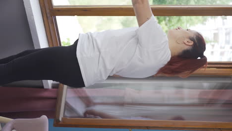 vídeo vertical de la mujer que abre las cortinas bostea y se relaja.