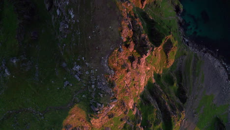 birds eye view of steep drop off cliff on the peak of matinden, andoya, with scenic sea view