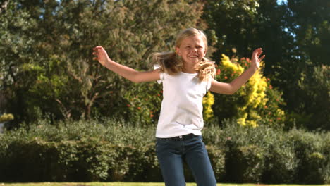 Niña-Alegre-Saltando-En-Su-Jardín