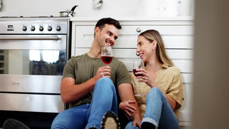 Couple-on-floor-in-kitchen-with-wine