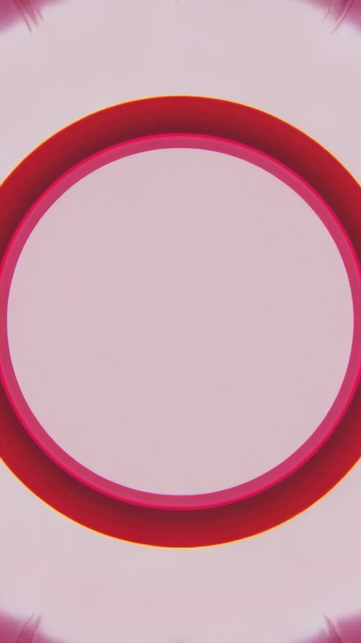 Vertical video: Opening sequence showing concentric ring pulsing on pink field, emitting red glow