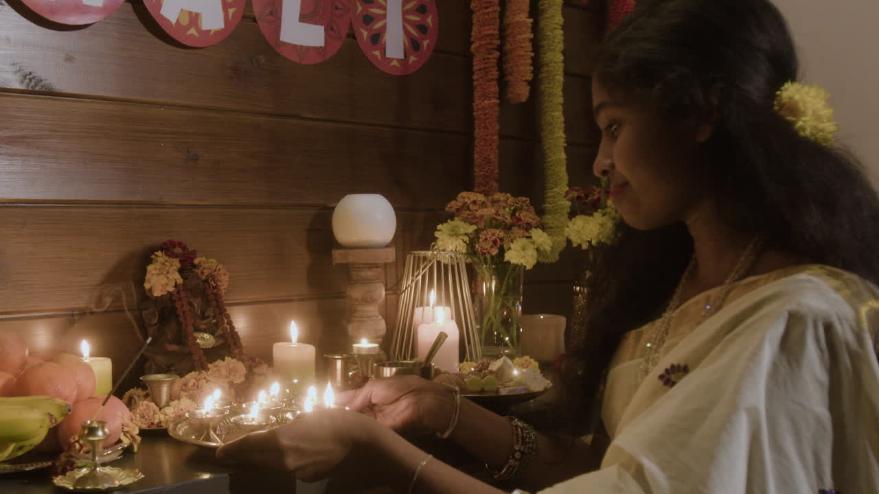 Woman lighting candles for Diwali