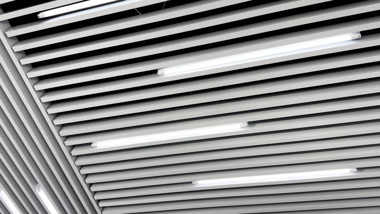 Lamps of day light switched on the ceiling. Long led illumination equipment black and white video. Low angle view.