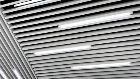 lamps of day light switched on the ceiling. long led illumination equipment black and white video. low angle view.