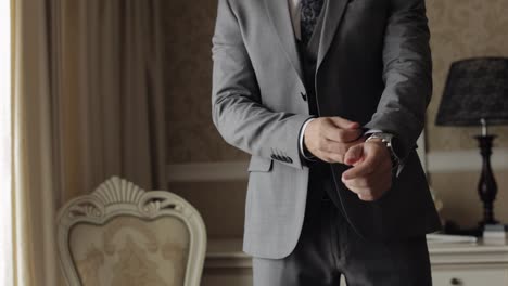 Handsome-groom-businessman-wearing-gray-jacket-at-home-in-living-room,-white-shirt-with-black-tie