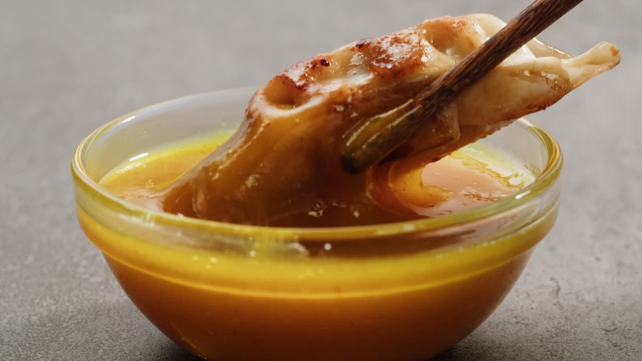 Gyoza Dipping in Mustard Sauce