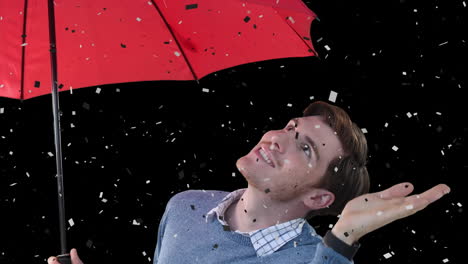 animation of confetti falling over caucasian man holding umbrella on black background