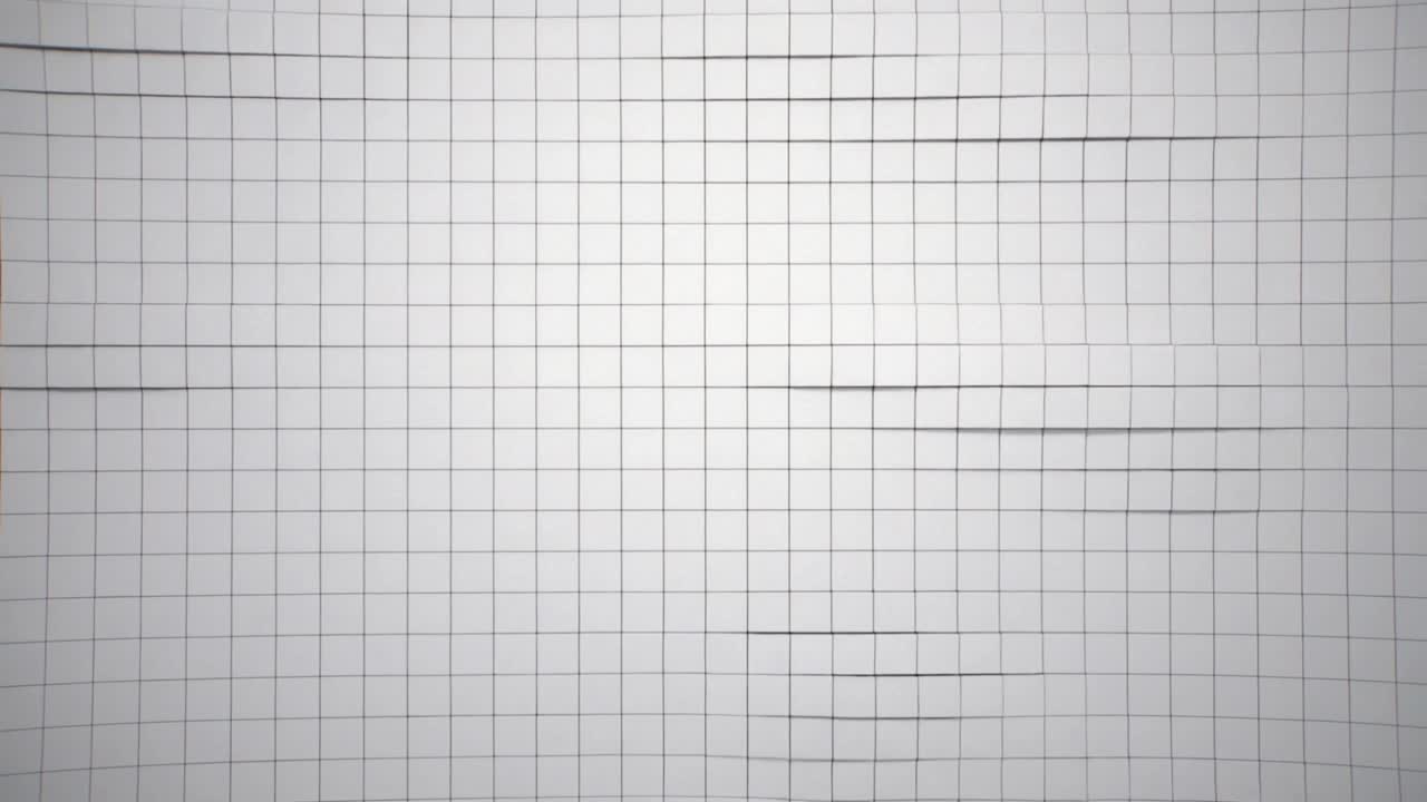 Shifting camera showing white graph paper grid filling frame on table, forming dark bands and warp