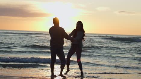 happy, sunset and silhouette of couple at beach