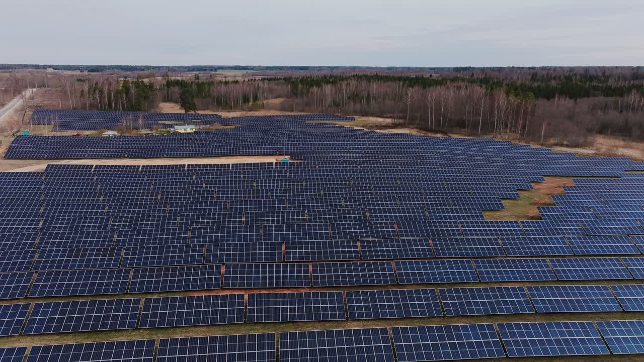 Aerial drone shot showing solar panel field around countryside house Latvia
