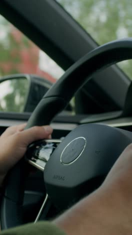 driver's hands on the steering wheel of a car