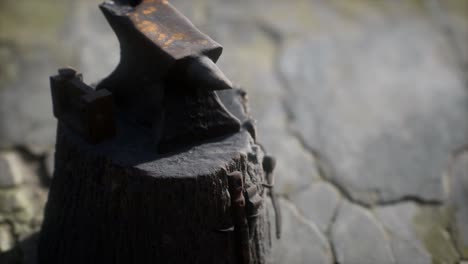 old anvil attached to a stump