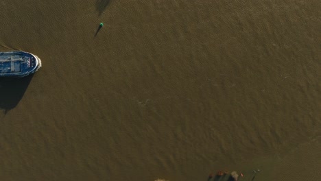 Aerial-birdseye-view-of-a-afrieghter-steaming-up-the-Lek-river-that-has-turned-brown-from-the-severe-flooding