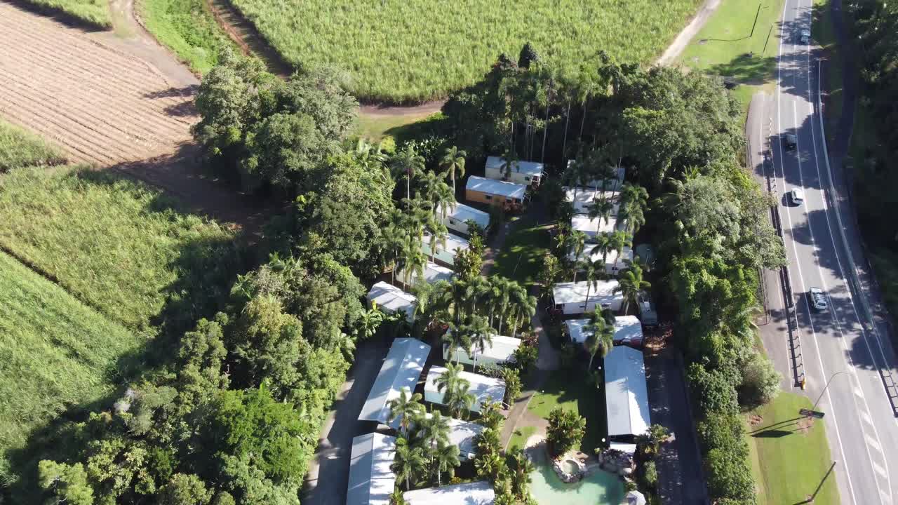 4K drone shot part of a small town, a tropical holiday resort and a sugarcane plantation in North Queensland, Australia