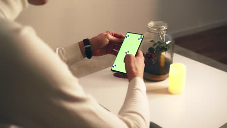 man hold smartphone with chromakey closeup