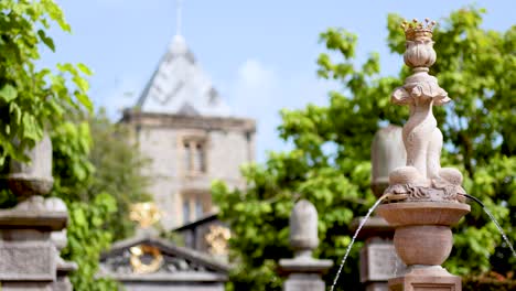 water flowing from a decorative statue fountain