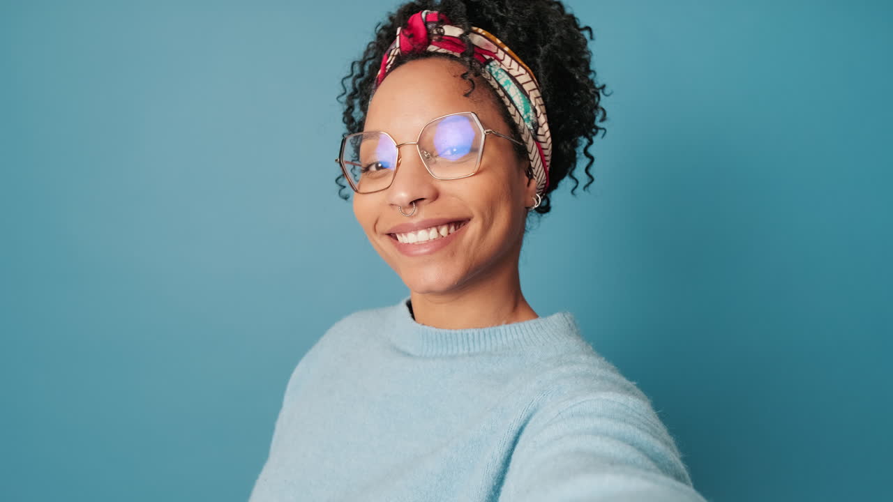 Portrait of a smiling woman with headband and glasses