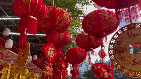 slowmotion shot of colorful red and golden chinese lanterns sold on an asian street market prior to the tet holiday or lunar new year in asia. tet concept. travel to asia