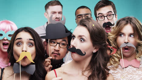 multi racial group of funny people celebrating slow motion party photo booth