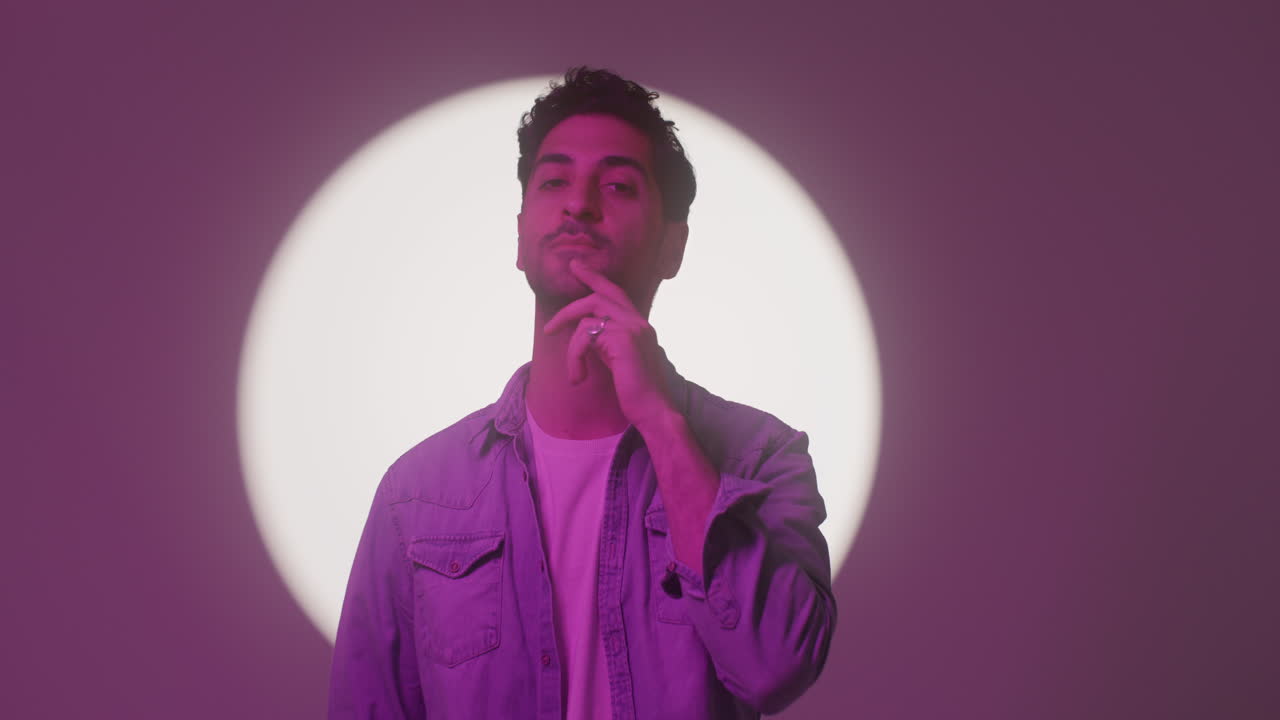 A Good Looking Man Touches His Beard