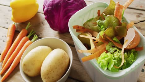 close up video of unprepared vegetables and organic waste in kitchen composting bin