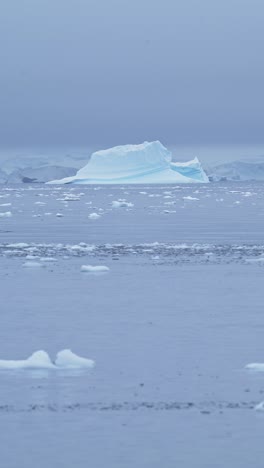 Iceberg-in-Ocean-Sea-Water-in-Antarctica,-Vertical-Video-for-Social-Media,-Instagram-Reels-and-Tiktok-of-Antarctic-Peninsula-Winter-Seascape-and-Icy-Landscape-Scenery