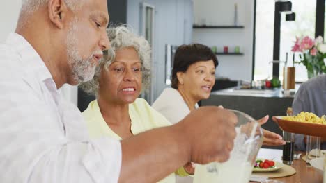 Happy-senior-diverse-people-having-dinner-at-retirement-home