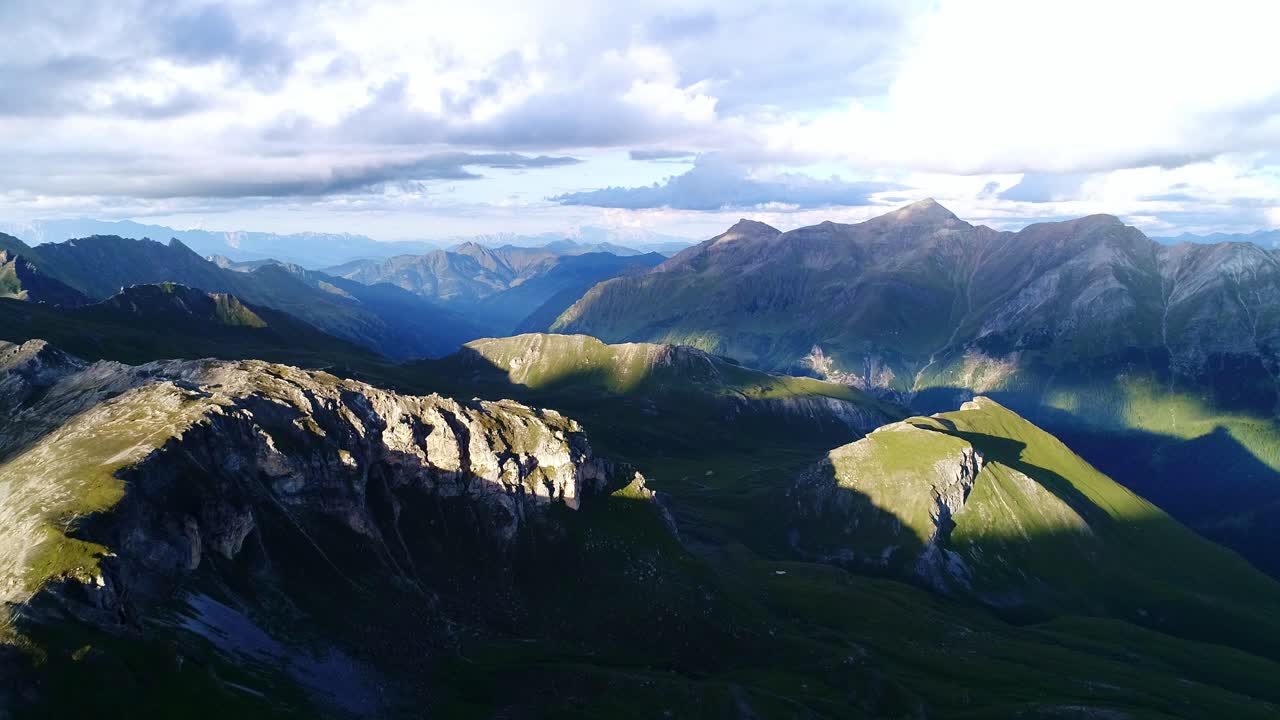 Grossglockner Alps stretch endlessly under dramatic evening skies, sunset time