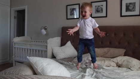 jumping off of happiness on the bed looking at flying soap bubbles