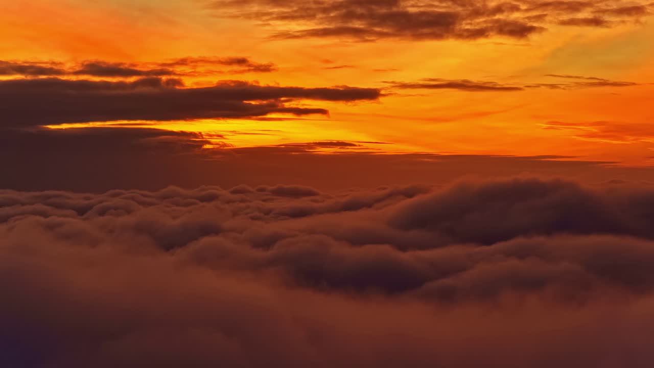 A Breathtaking Sunset Above the Clouds, Painting the Sky in Shades of Orange and Gold - Wide Shot
