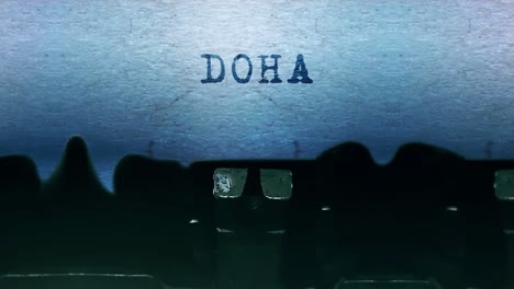 doha word closeup being typing and centered on a sheet of paper on old vintage typewriter mechanical