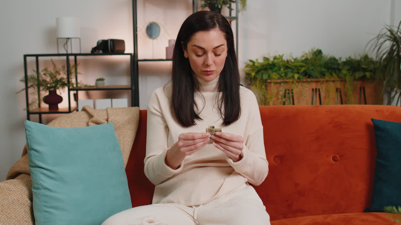 Poor young woman holding piggybank and one dollar banknote financial crisis bankruptcy poverty