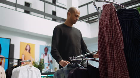 man shopping for clothes in a modern retail store