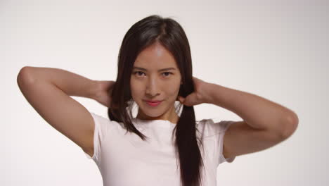 young woman in front of white studio background posing for photo booth style portraits 2