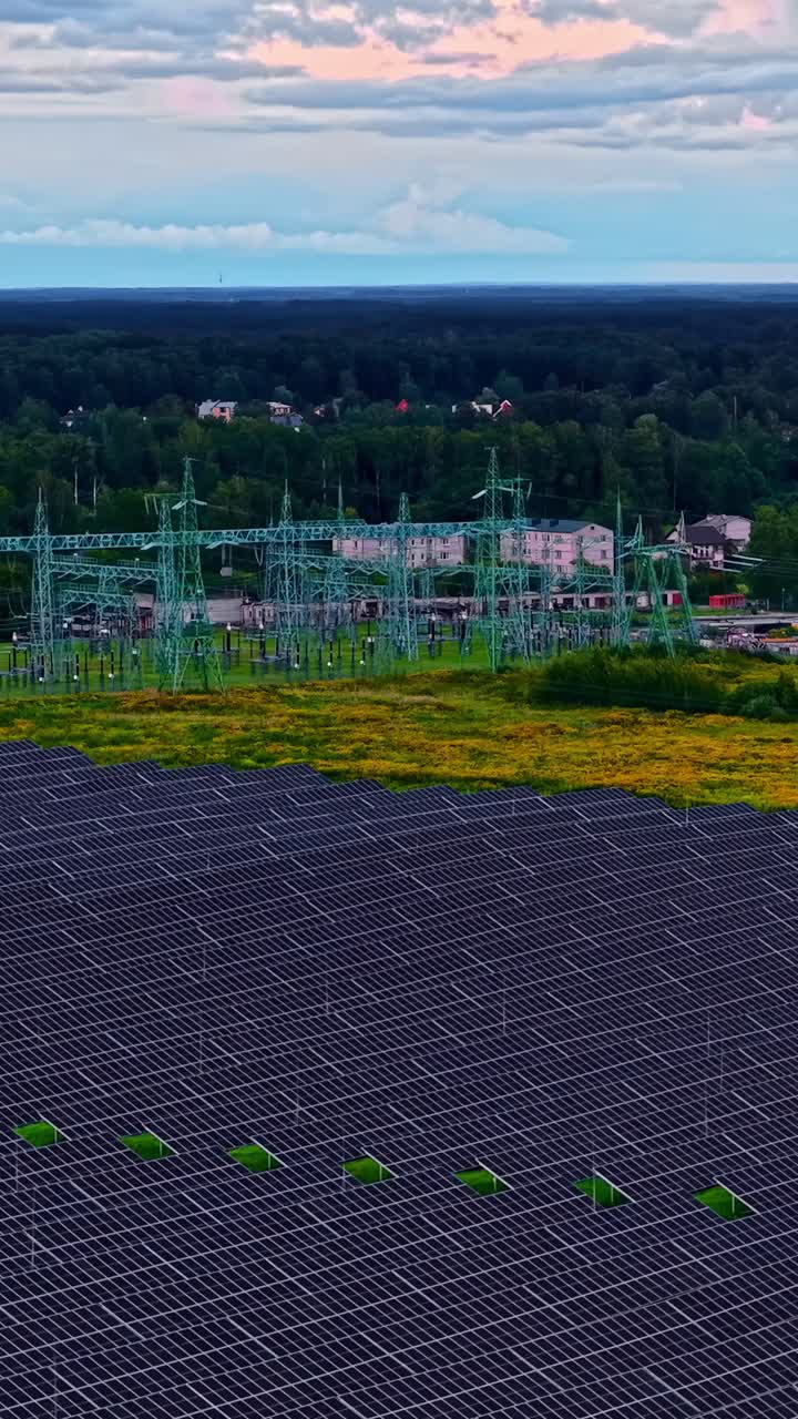 Vertical of solar field with nearby grid transformers and access pathways visible